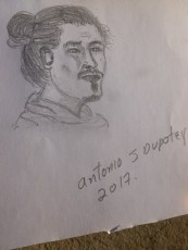 42. Pendant que nous nous reposons sur un banc, un artiste croque Quentin et nous donne son dessin...